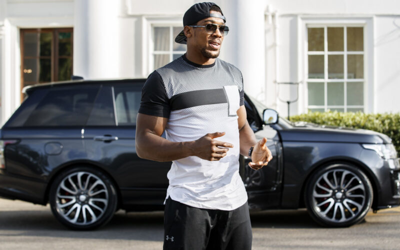 Anthony Joshua with his Range Rover in background.