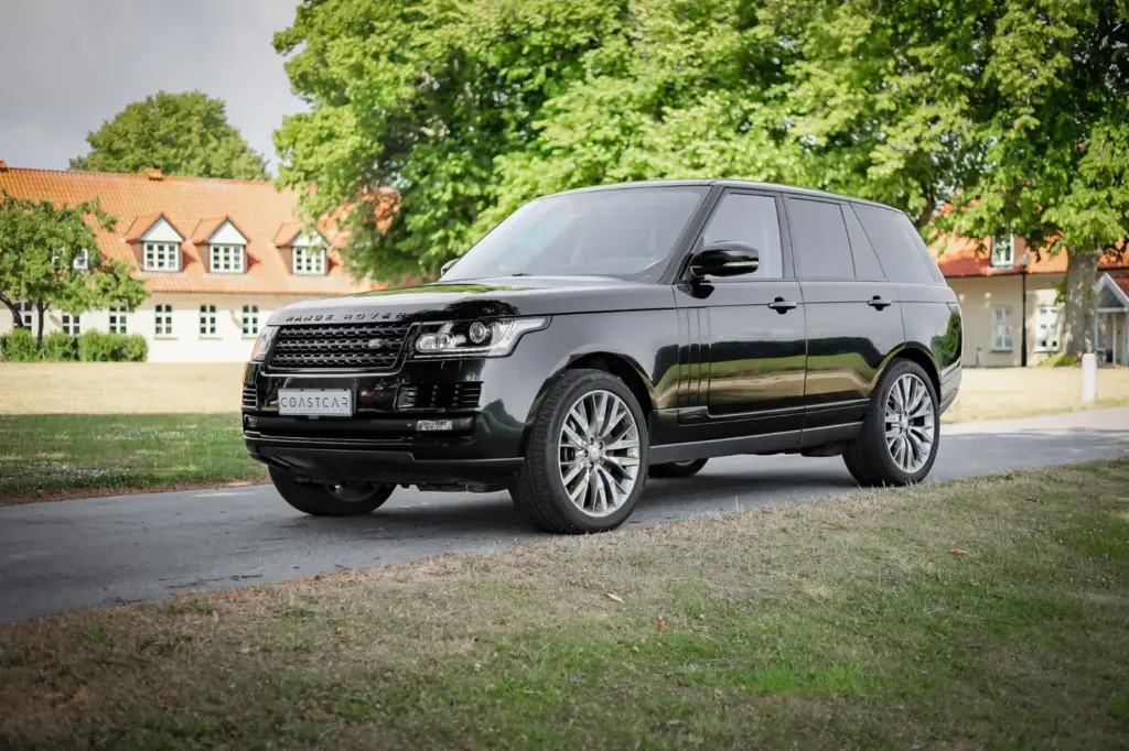 Range Rover all black in the countryside.